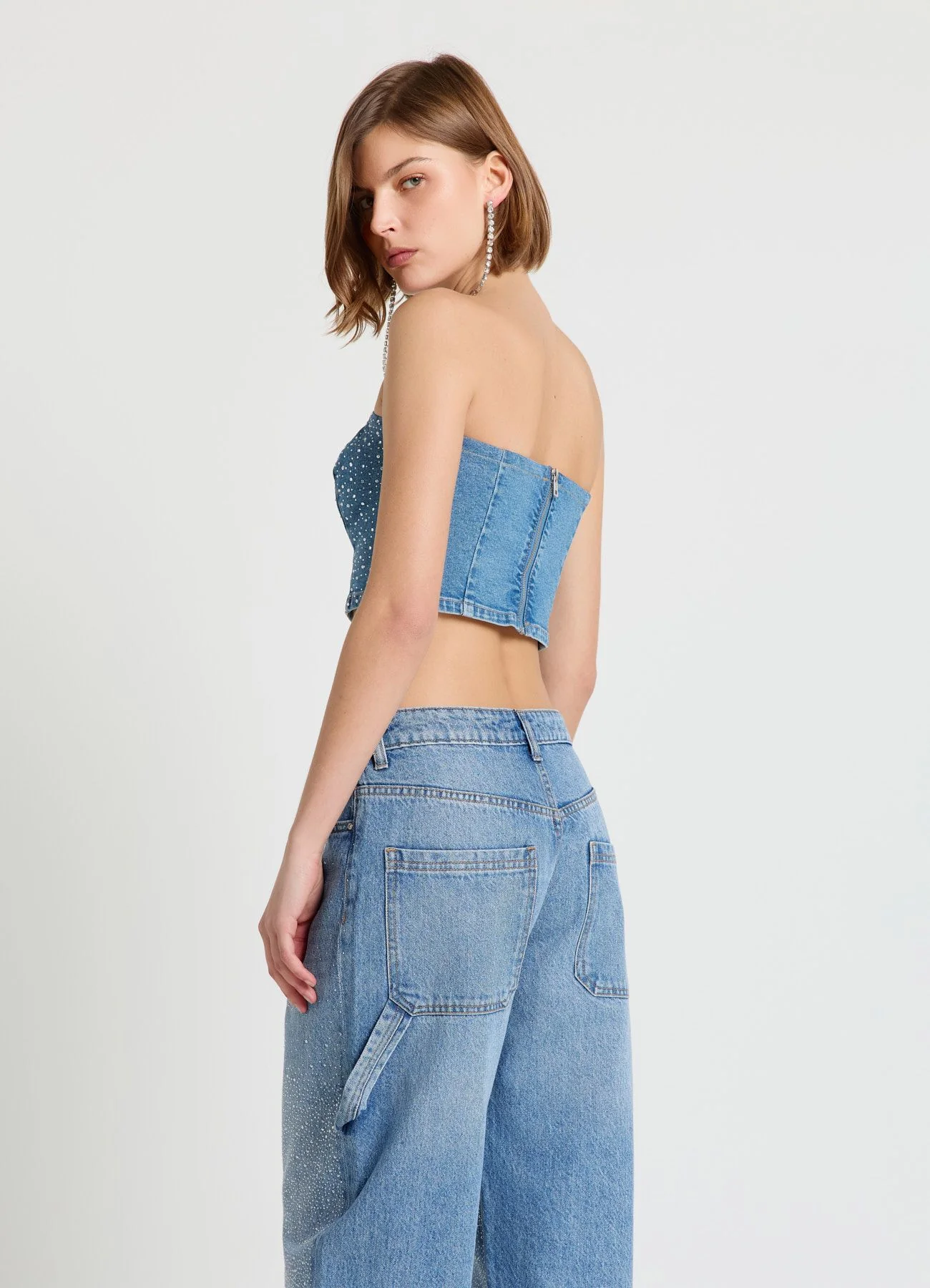 Top a fascia in denim con strass